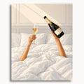 Champagne in Bed: two hands holding a champagne bottle and flute above rumpled white bedding.