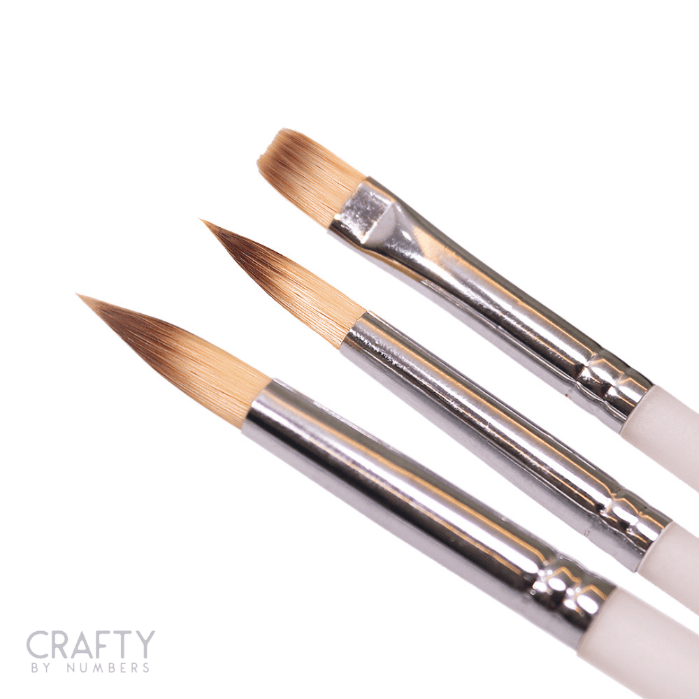 A set of three precision point brushes with flat bristles, metallic handles, and white detailing.