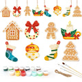 Set of Christmas-themed wooden ornaments with paint supplies on a white background