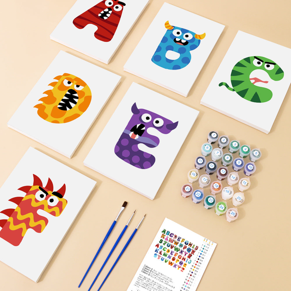 Colorful alphabet cards with paint bottles and brushes on a beige surface