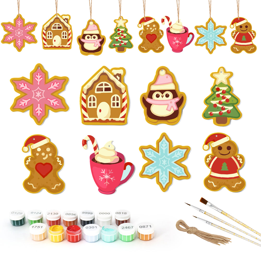 Set of Christmas-themed ceramic decorations with painting supplies on a white background