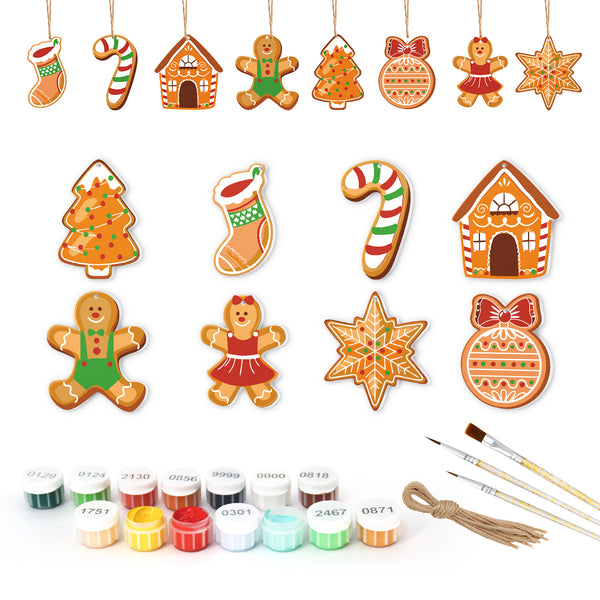 Collection of Christmas-themed cookie cutters with painting supplies on a white background