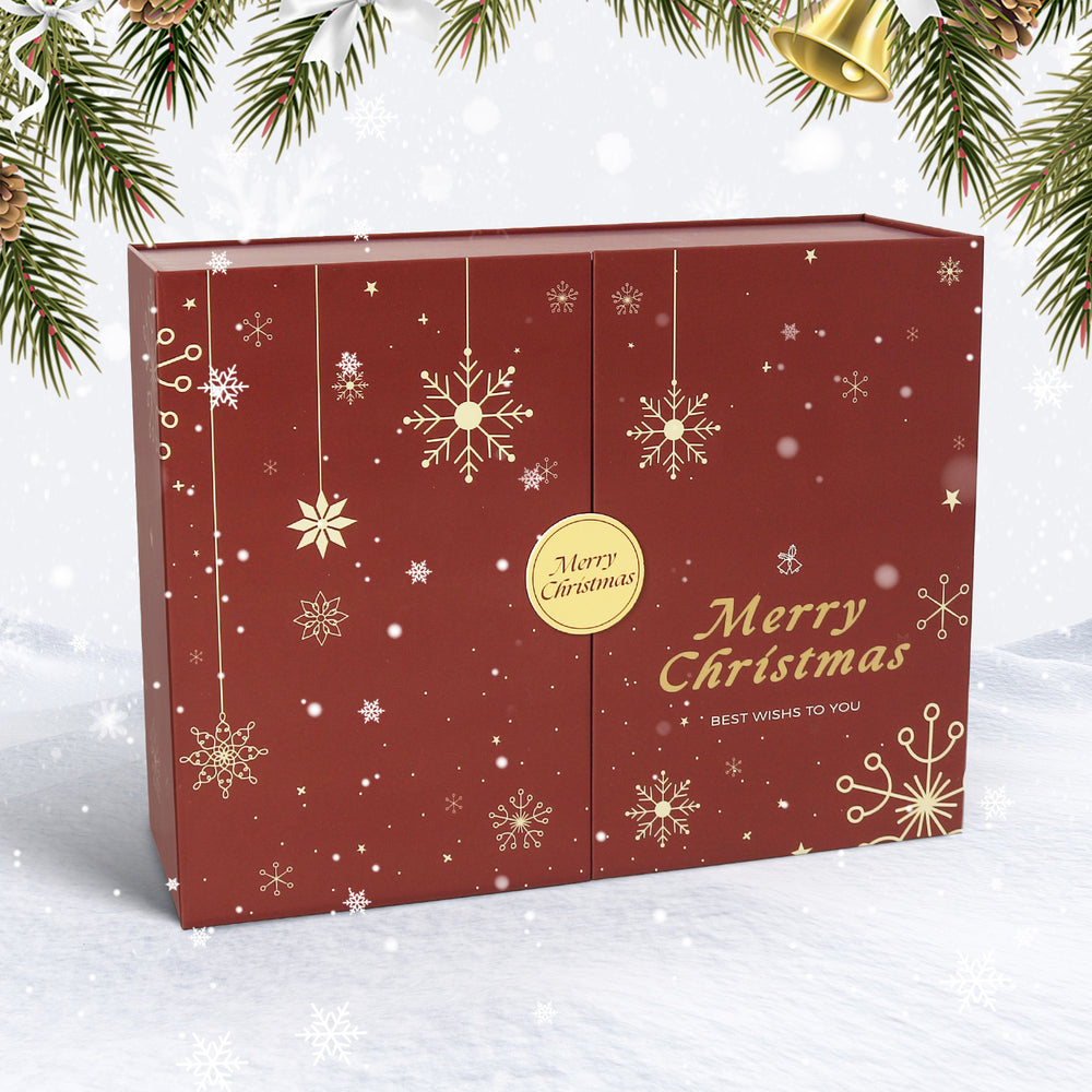 Red Christmas gift box with gold snowflakes and 'Merry Christmas' text on a snowy background.