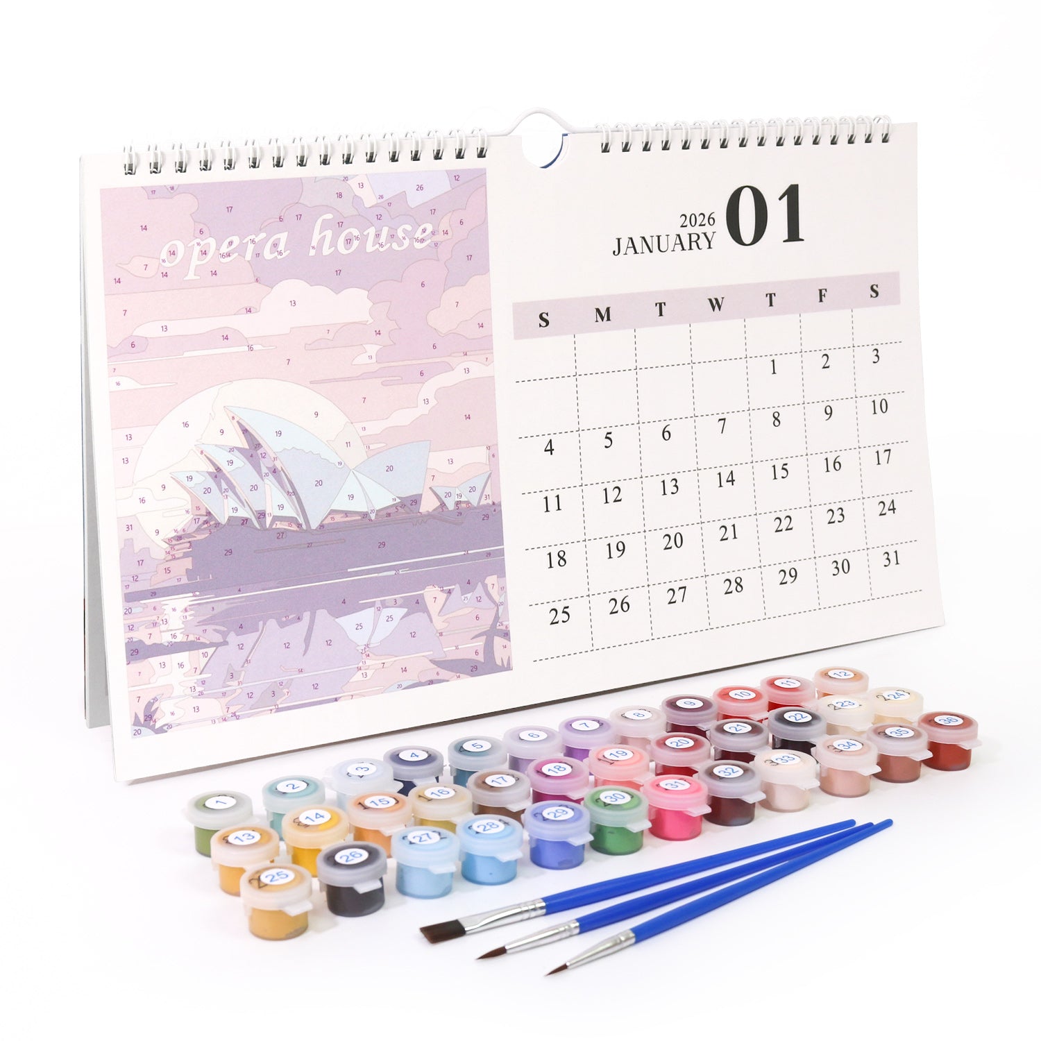 Calendar with art supplies including paint pots and brushes on a white background