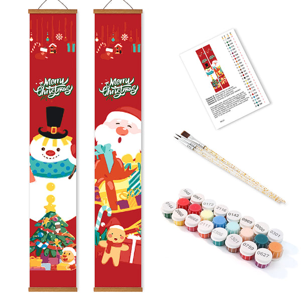 Two Christmas-themed scroll paintings with paint supplies on a white background