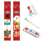 Two Christmas-themed scroll paintings with paint supplies on a white background