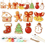 Set of Christmas-themed ceramic decorations with painting supplies on a white background