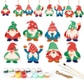 Set of colorful gnome ornaments with painting supplies on a white background