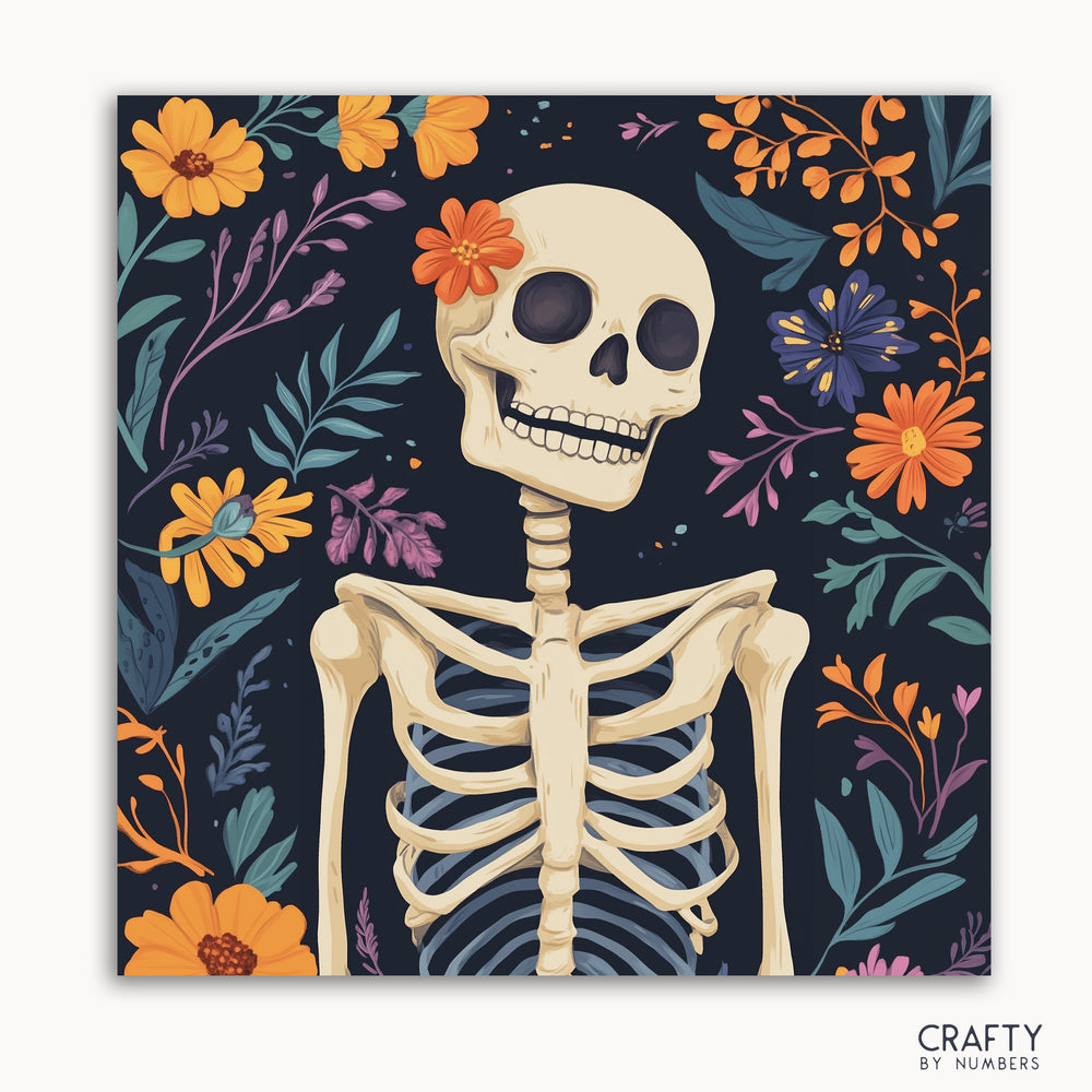 A paint by numbers kit featuring a skeleton with flowers and leaves in vibrant colors on a black background.