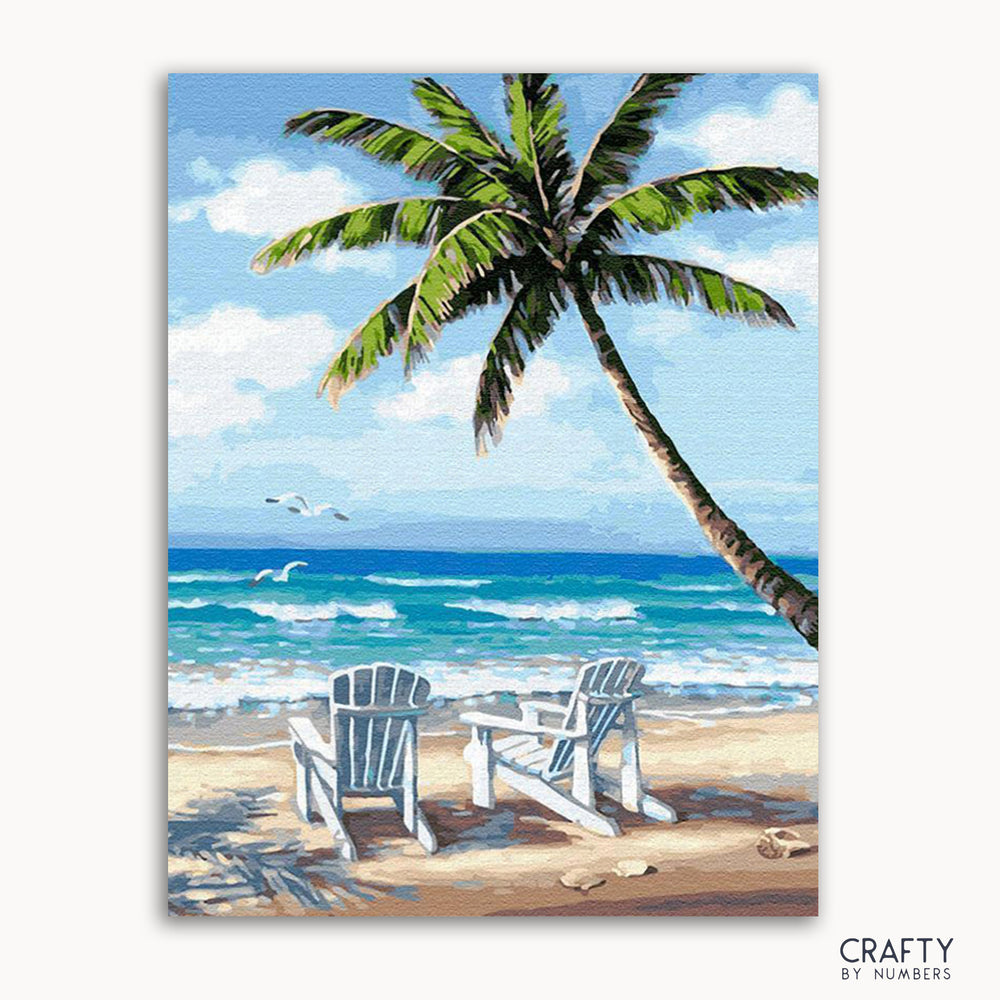A painted image depicting a beach scene with a palm tree, two deck chairs, and the ocean in the background.