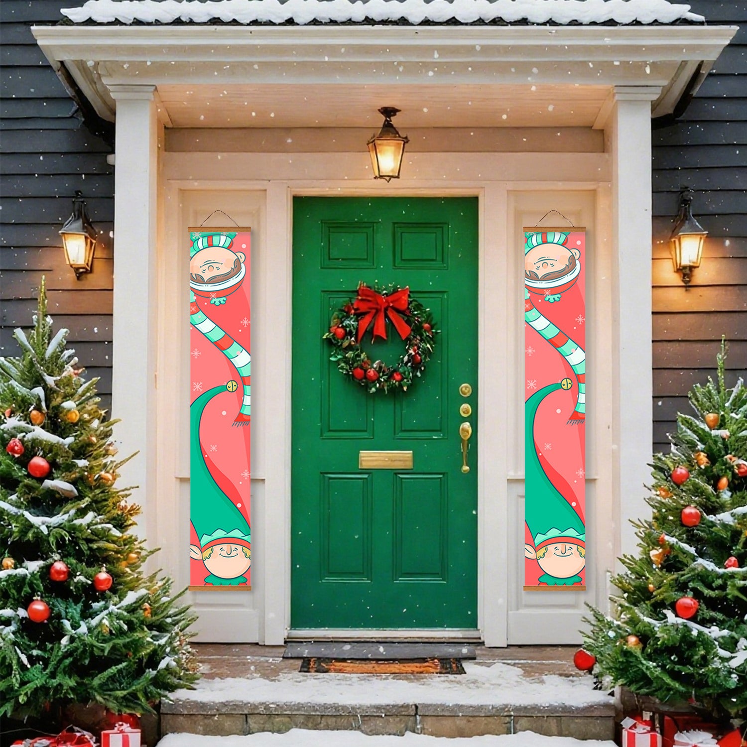Green door with Christmas wreath flanked by two festive elf banners, surrounded by snow-covered trees and lights.