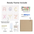 Set of art supplies including acrylic paints, brushes, a linen canvas, and other materials on a white background.
