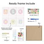 Set of art supplies including acrylic paints, brushes, a linen canvas, and letter stickers on a white background.