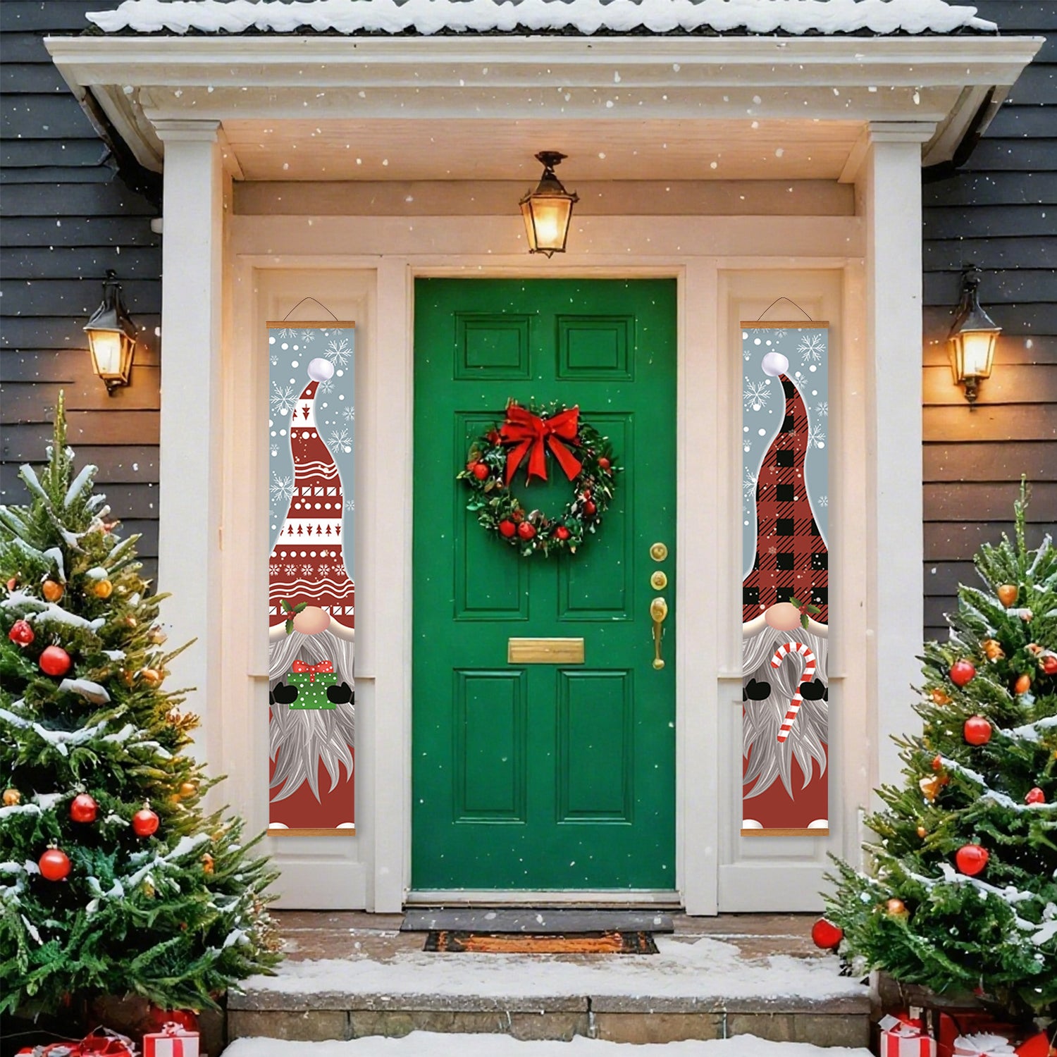 Decorative front door with wreath and window decorations, flanked by Christmas trees and snow.