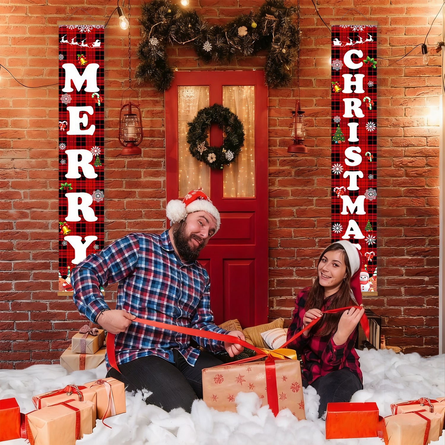 Two people sitting on a snowy floor with Christmas presents and decorations, including a red door and festive signs.
