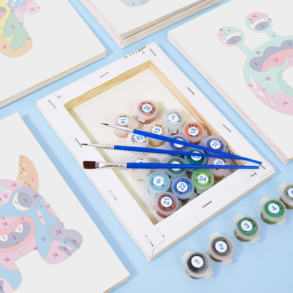 Set of paint tubes and brushes on a table with art supplies