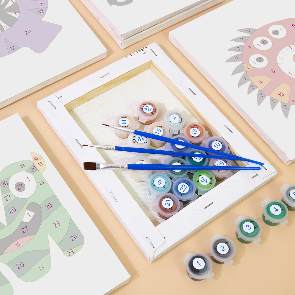 Set of paintbrushes and color swatches on a table with art supplies.