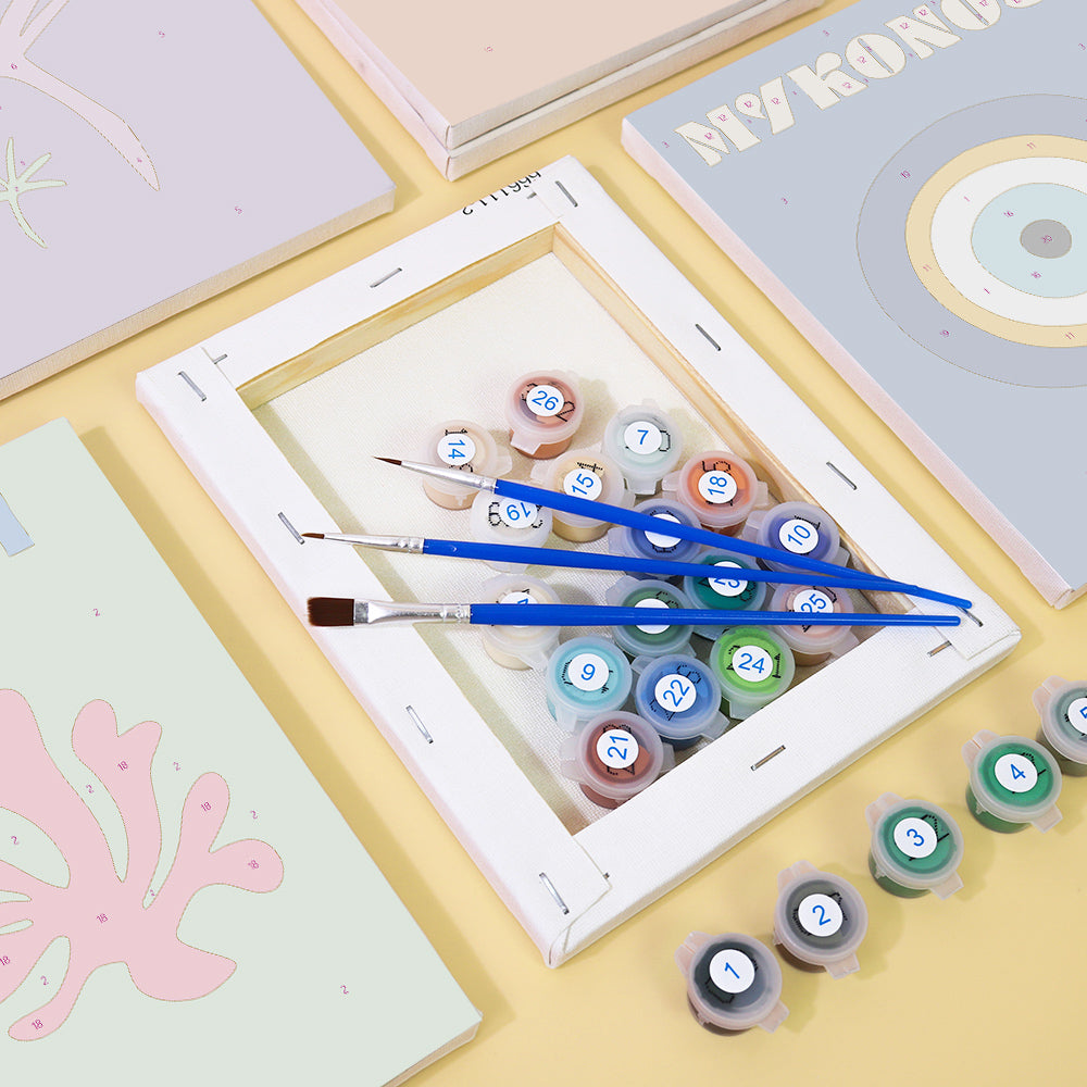 Hand holding a brush painting a Mini Escapes kit section