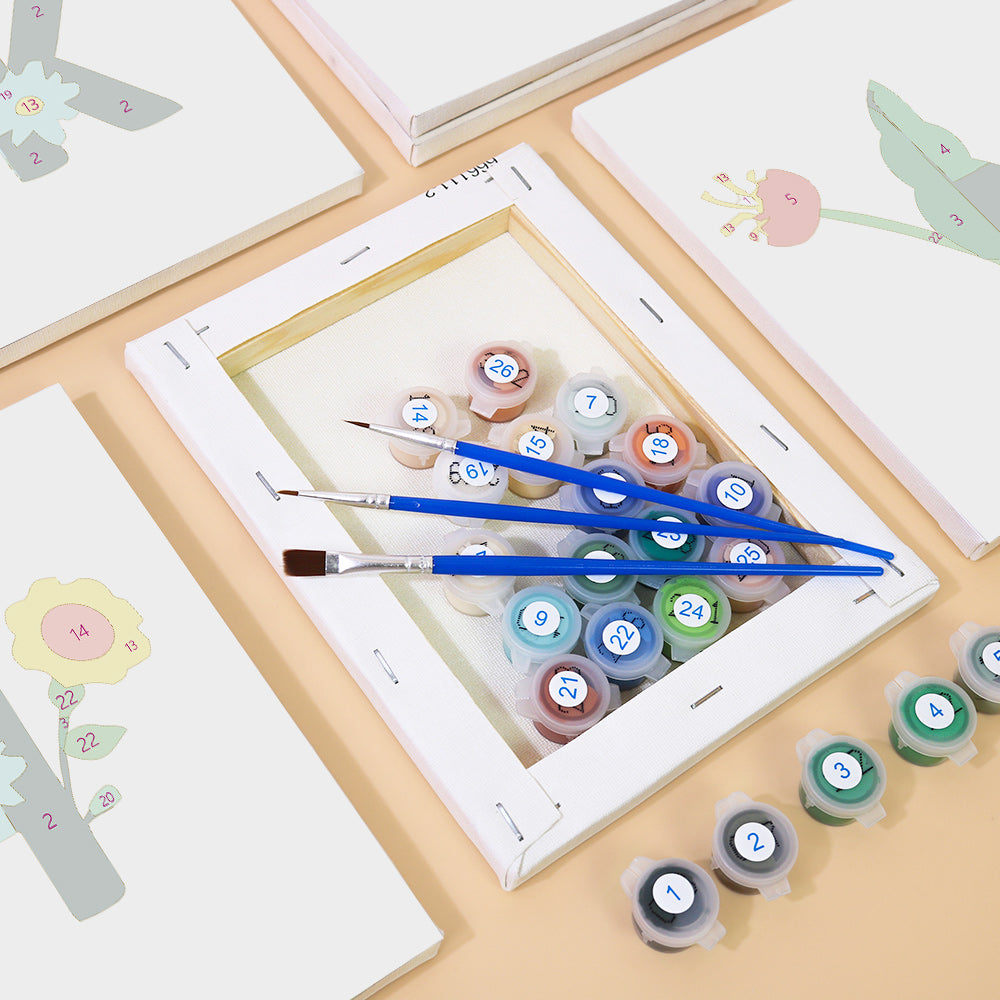 Set of paintbrushes and color swatches on a wooden surface with a white frame.