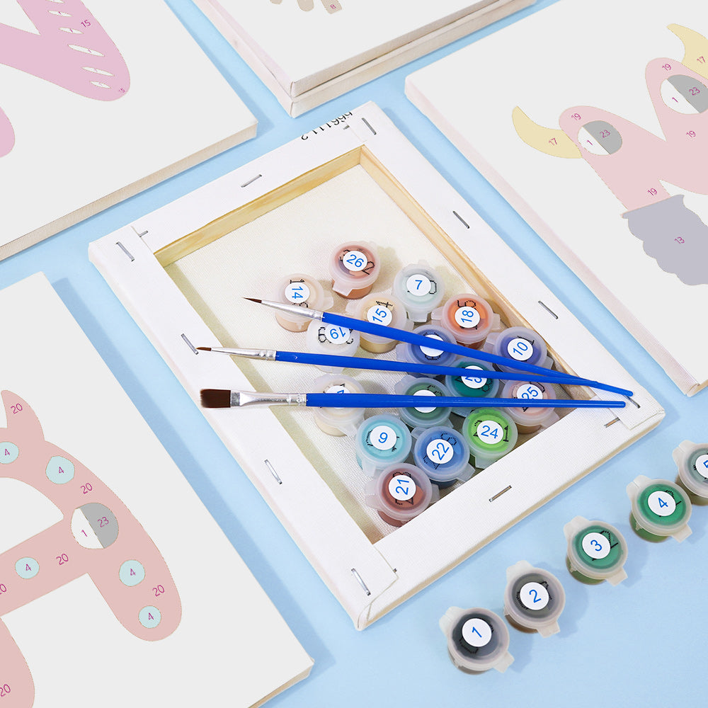 Set of paintbrushes and color swatches on a table with children's art supplies.