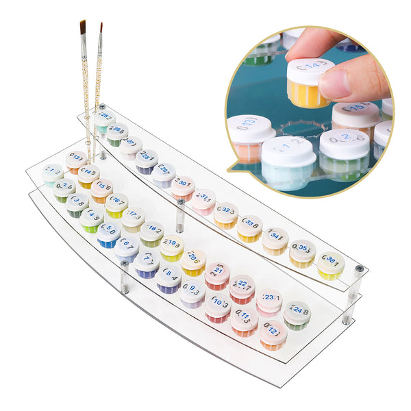 Set of watercolor paint pots with a clear acrylic tray and brushes on a white background.