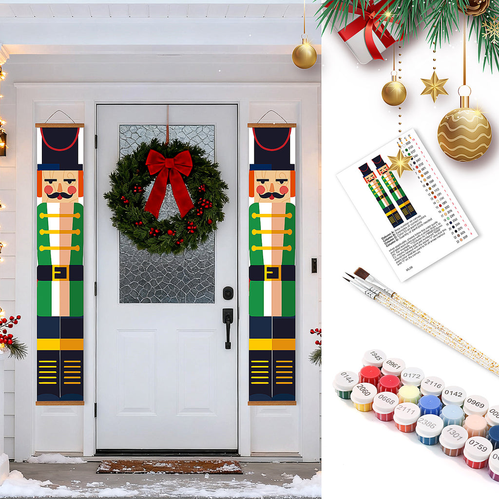 Decorative Nutcracker banners with a wreath on a door, paint swatches, and paintbrushes.