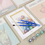 Hand holding a brush painting a mini paint by numbers canvas