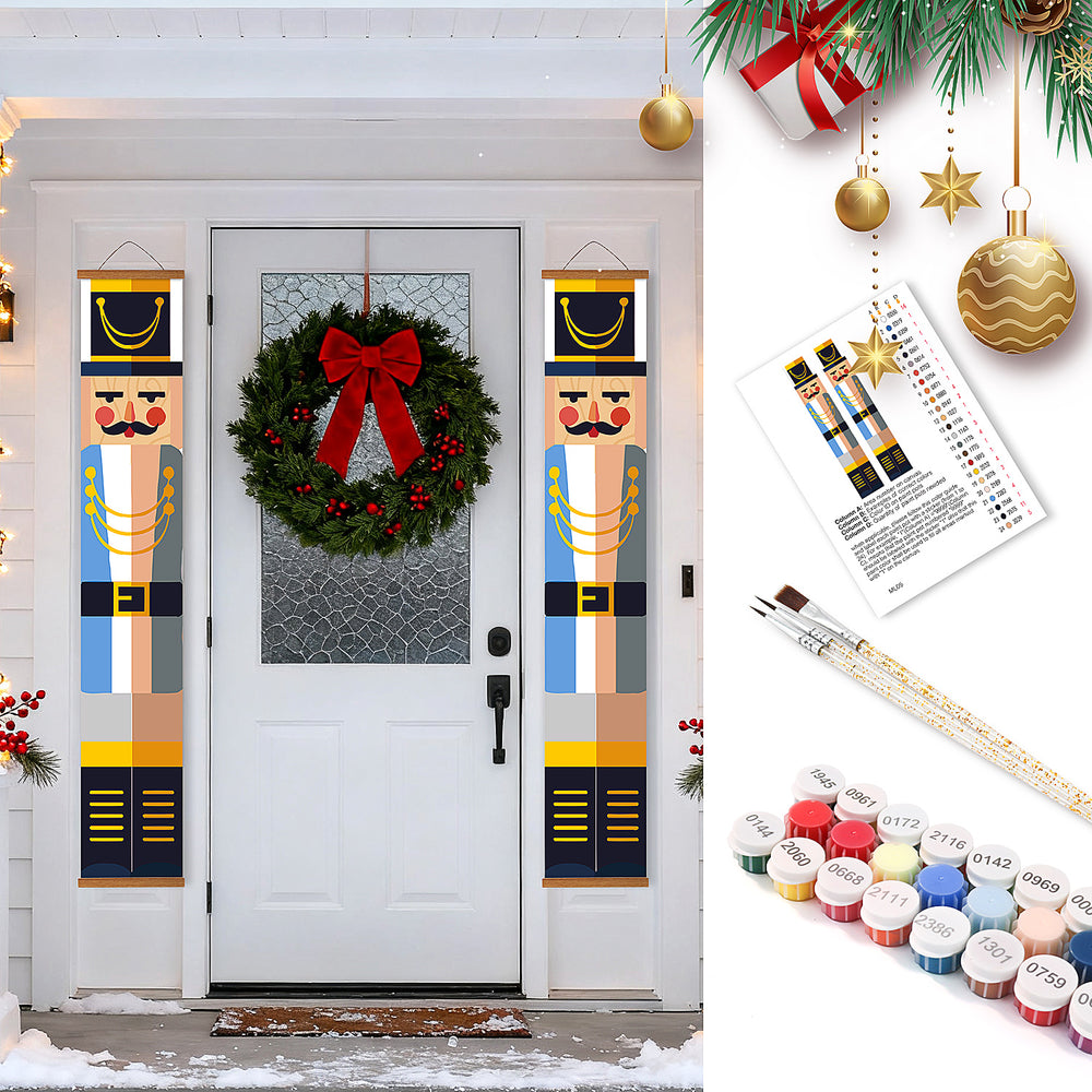Decorative nutcracker panels with a wreath on a door, paint swatches, and paintbrushes.