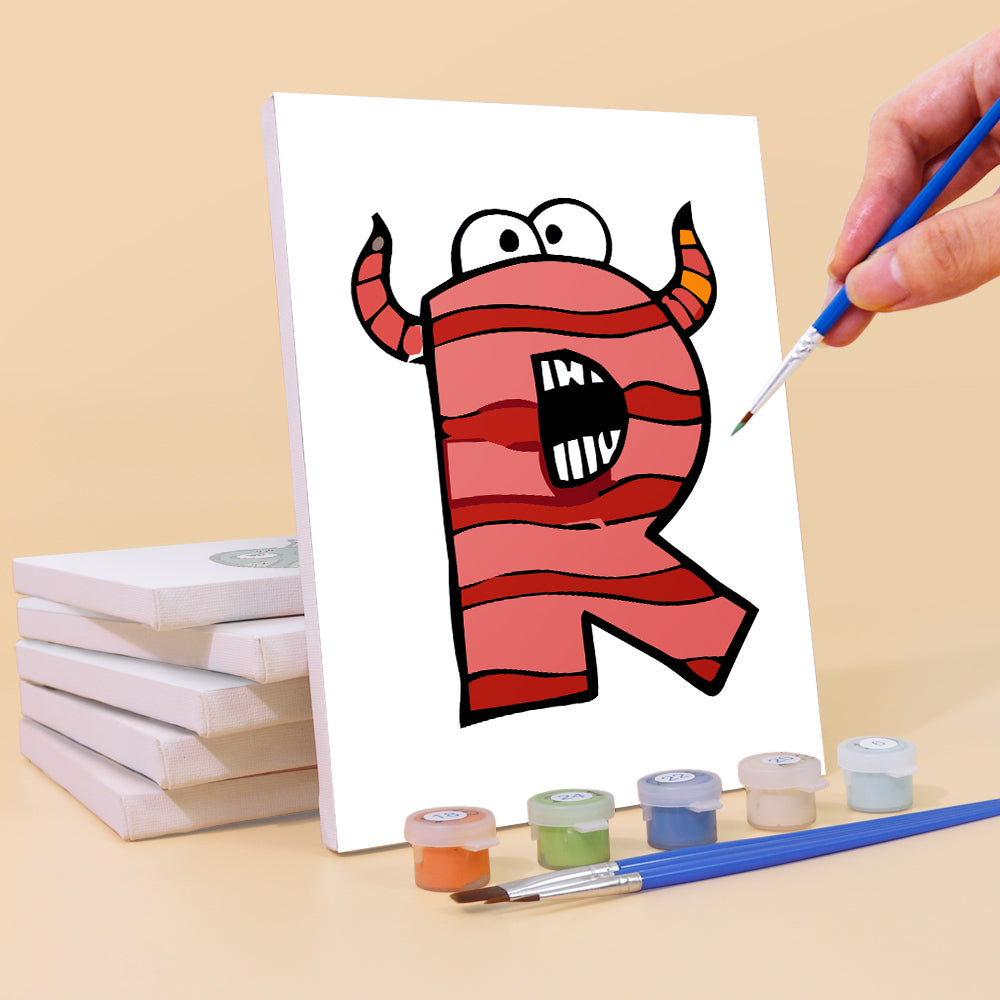 Hand painting a cartoon letter 'R' with a monster design on a white canvas, with paint supplies and additional canvases in the background.
