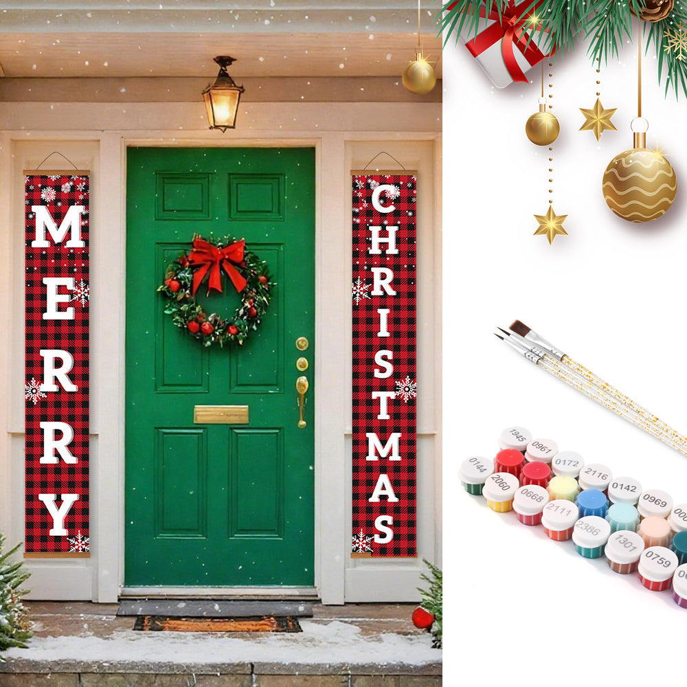 Decorative Christmas banners on a green door with a wreath, surrounded by festive decorations and paint supplies.
