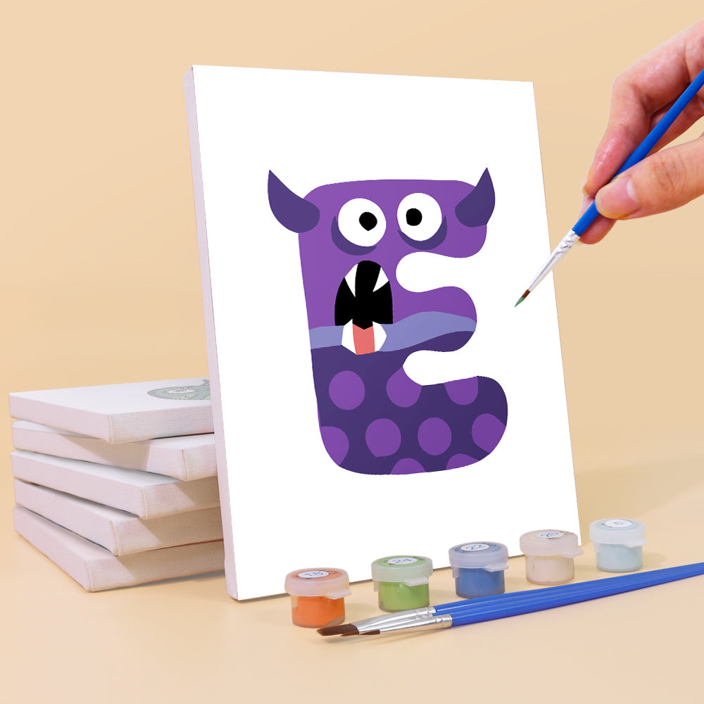 Hand painting a purple monster letter 'E' on a white canvas with paint supplies.