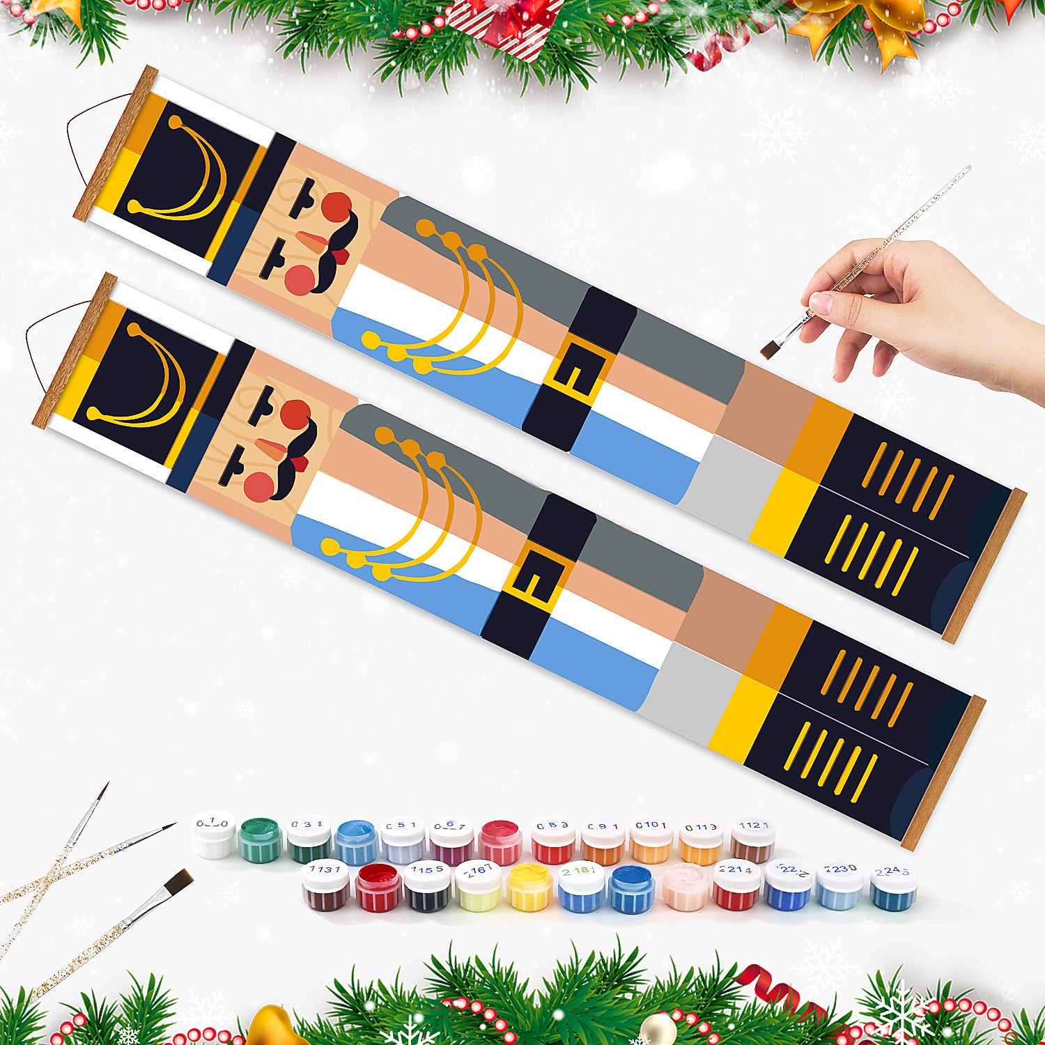 Dekorative rollende Maltafeln mit einer Hand, die einen Pinsel hält, umgeben von Farbdosen und Weihnachtsdekorationen.