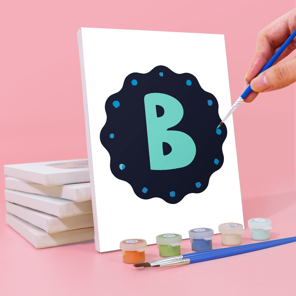 Person painting a letter 'B' on a canvas with paint supplies on a pink background