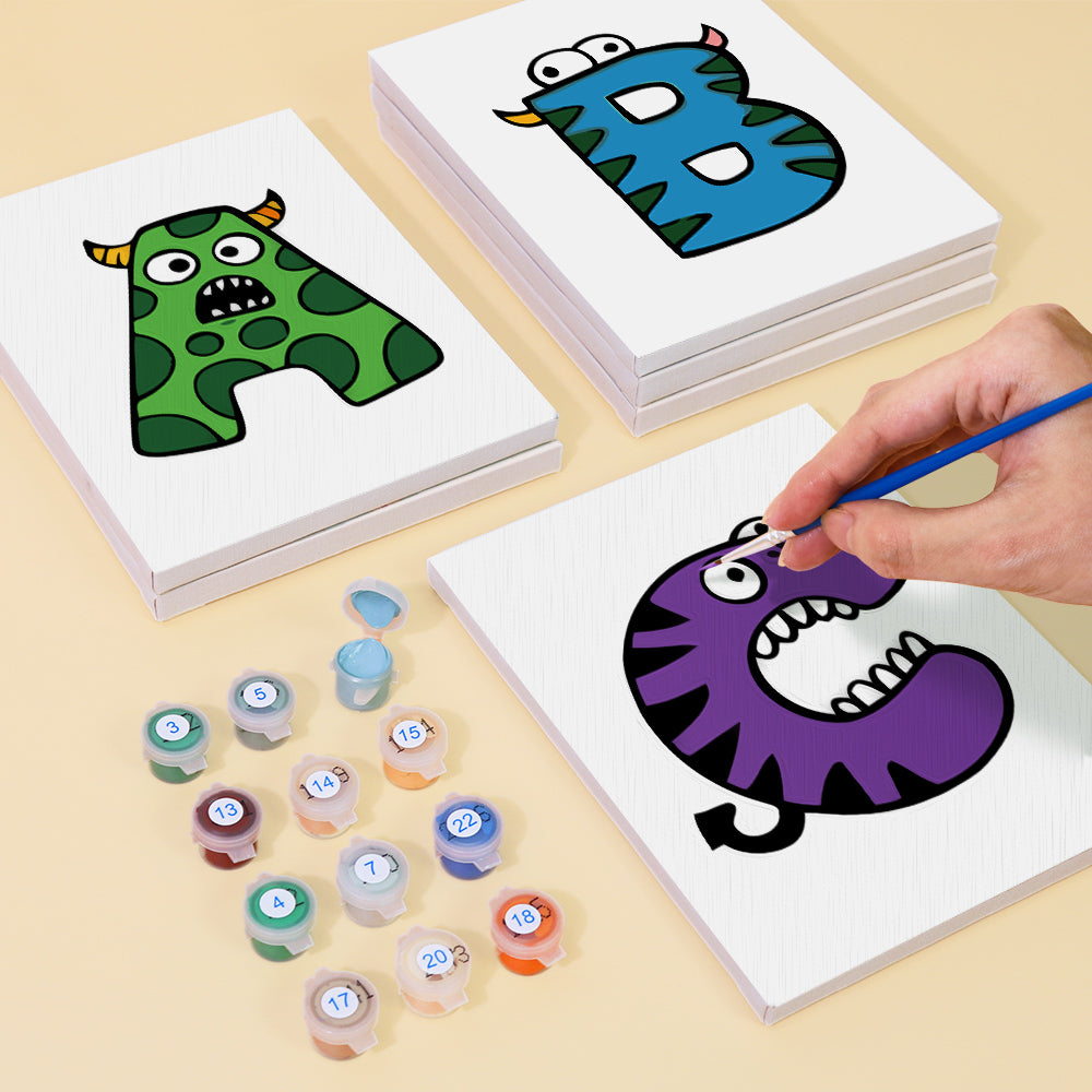 Coloring activity with alphabet cards and paint containers on a beige surface