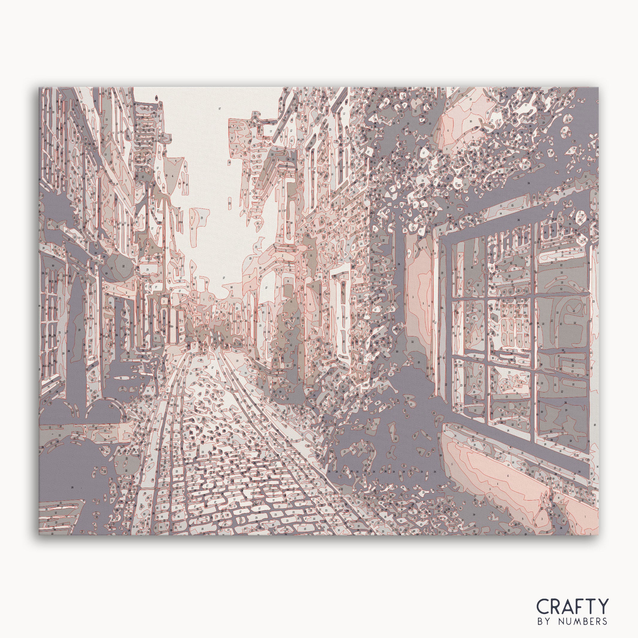 Paint by numbers kit of Old Town at sunset with warm glowing skies and rustic buildings