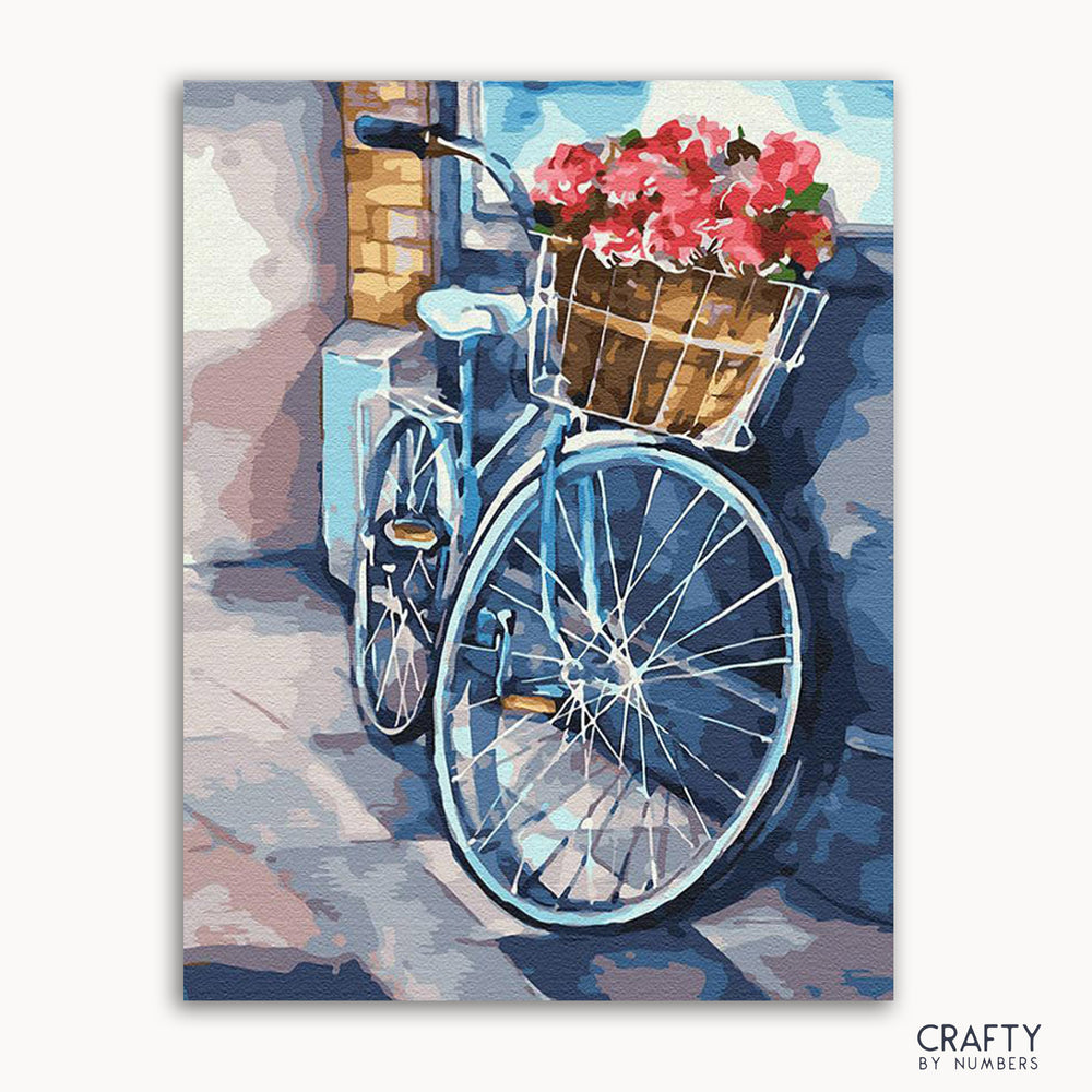 A painting kit representation of a bicycle with a basket of flowers, evoking a romantic and cozy feel.