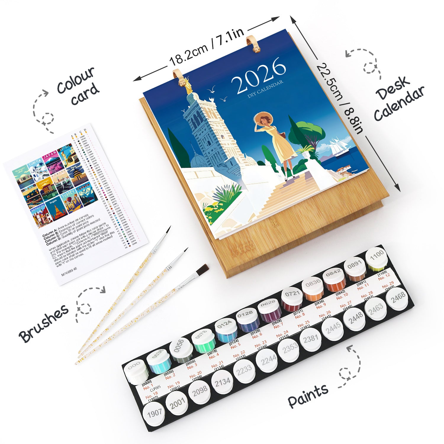 Artistic set with a desk calendar, paintbrushes, and paint tubes on a white background