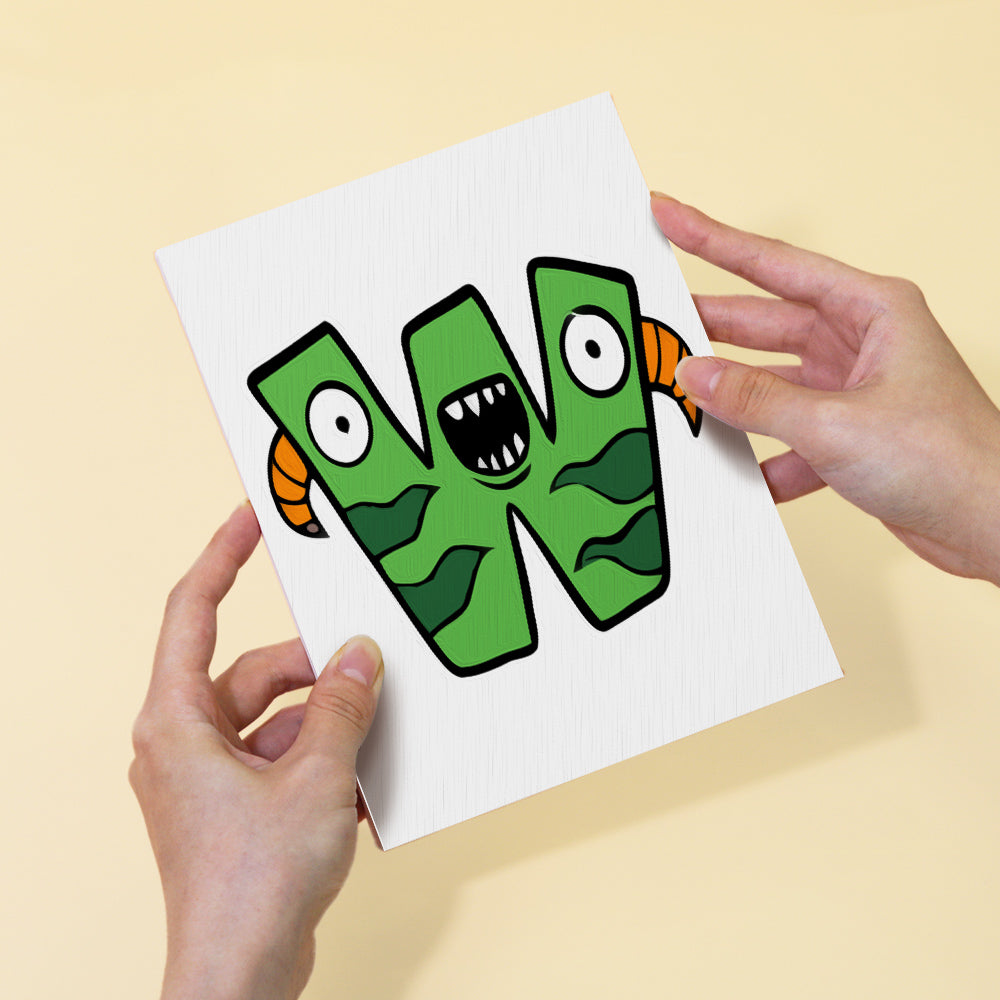 Hands holding a card with a green monster letter 'W' design on a beige background
