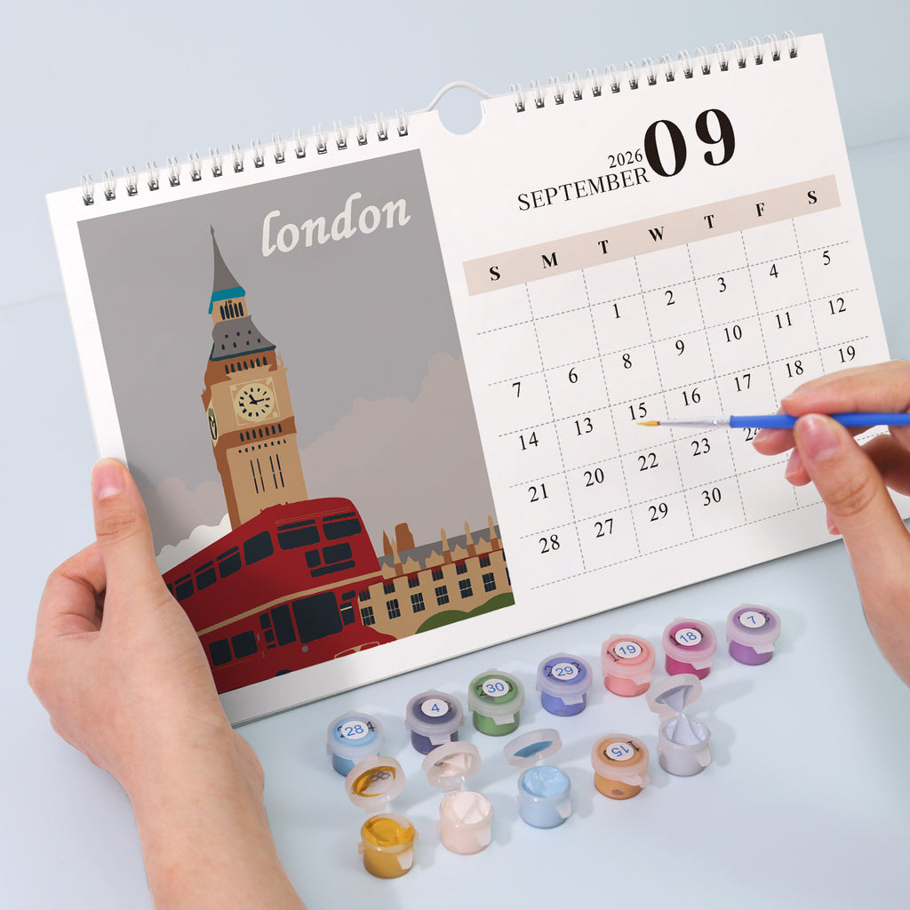 Kalender mit London-Illustration und Farbbehältern auf hellblauem Hintergrund