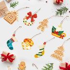 Collection of Christmas-themed paper ornaments on a white background