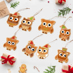 Decorative owl ornaments with Christmas hats on a white background with gift boxes and trees.
