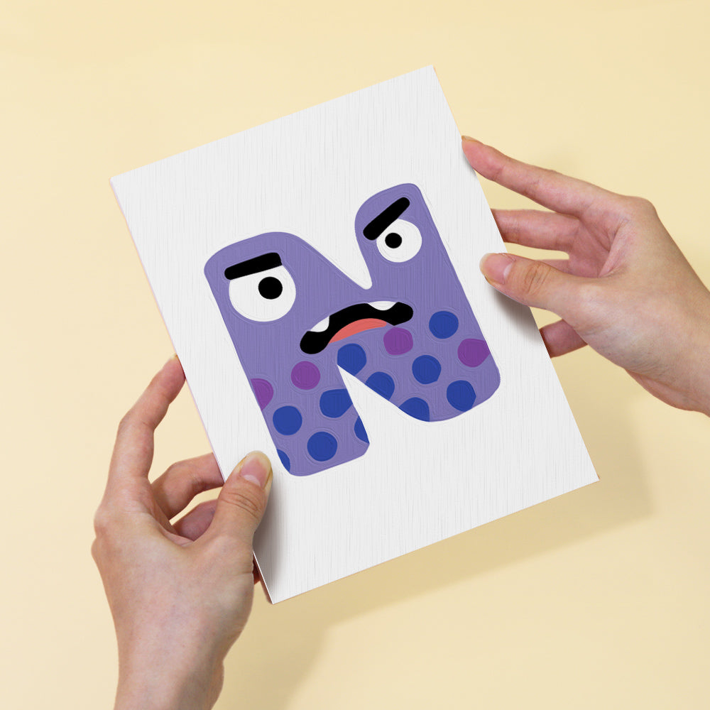 Card with a purple letter 'M' with a face held by two hands against a beige background