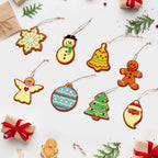 Colorful Christmas-themed cookie cutout ornaments on a white background with gift boxes and candy canes.