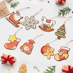 Collection of Christmas-themed ceramic ornaments on a white background with small gift boxes and candy canes.