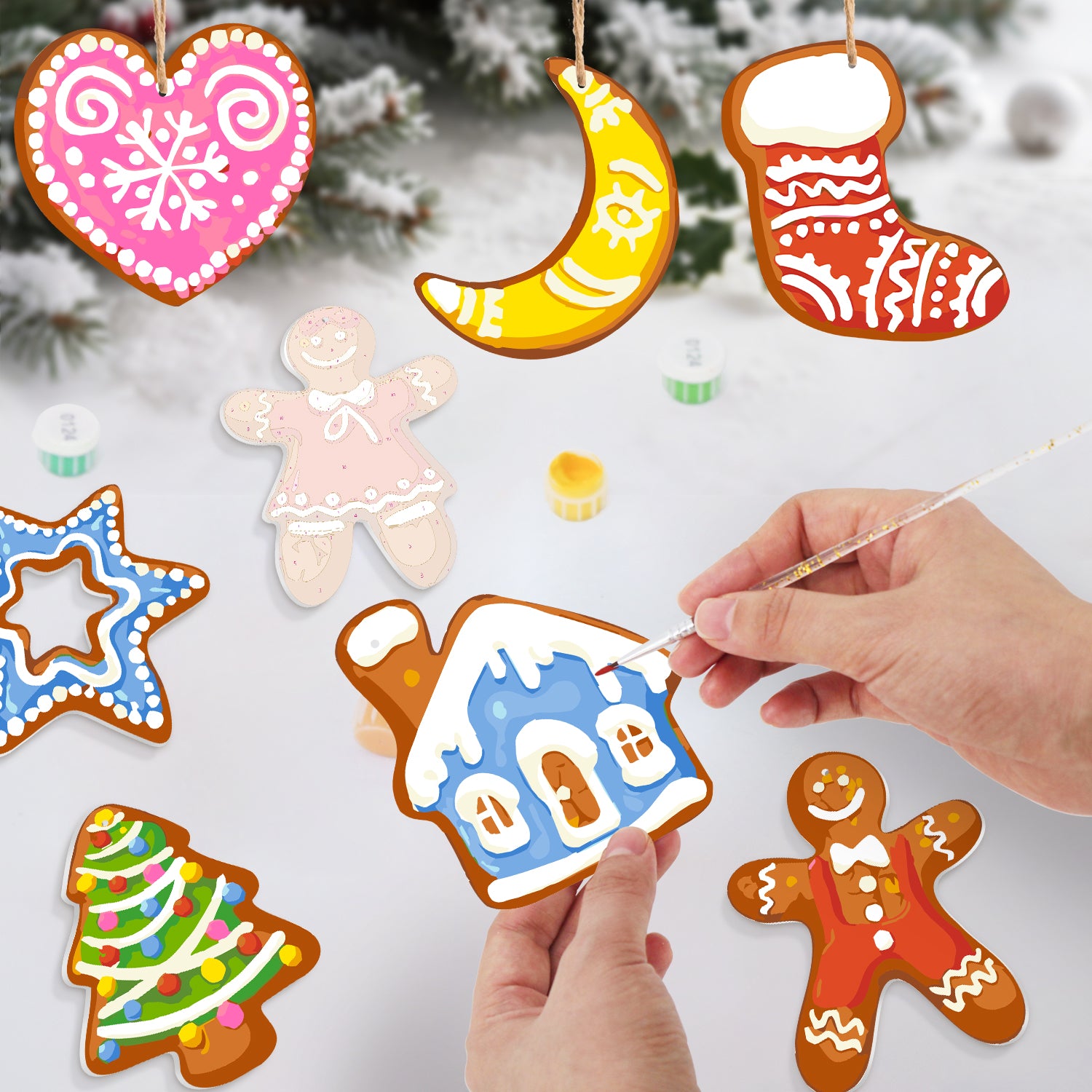 Decorative gingerbread cookies shaped like a heart, moon, stocking, star, tree, and gingerbread man on a snowy background.