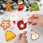 Hand-painted Christmas-themed cookies with a person using a paintbrush.
