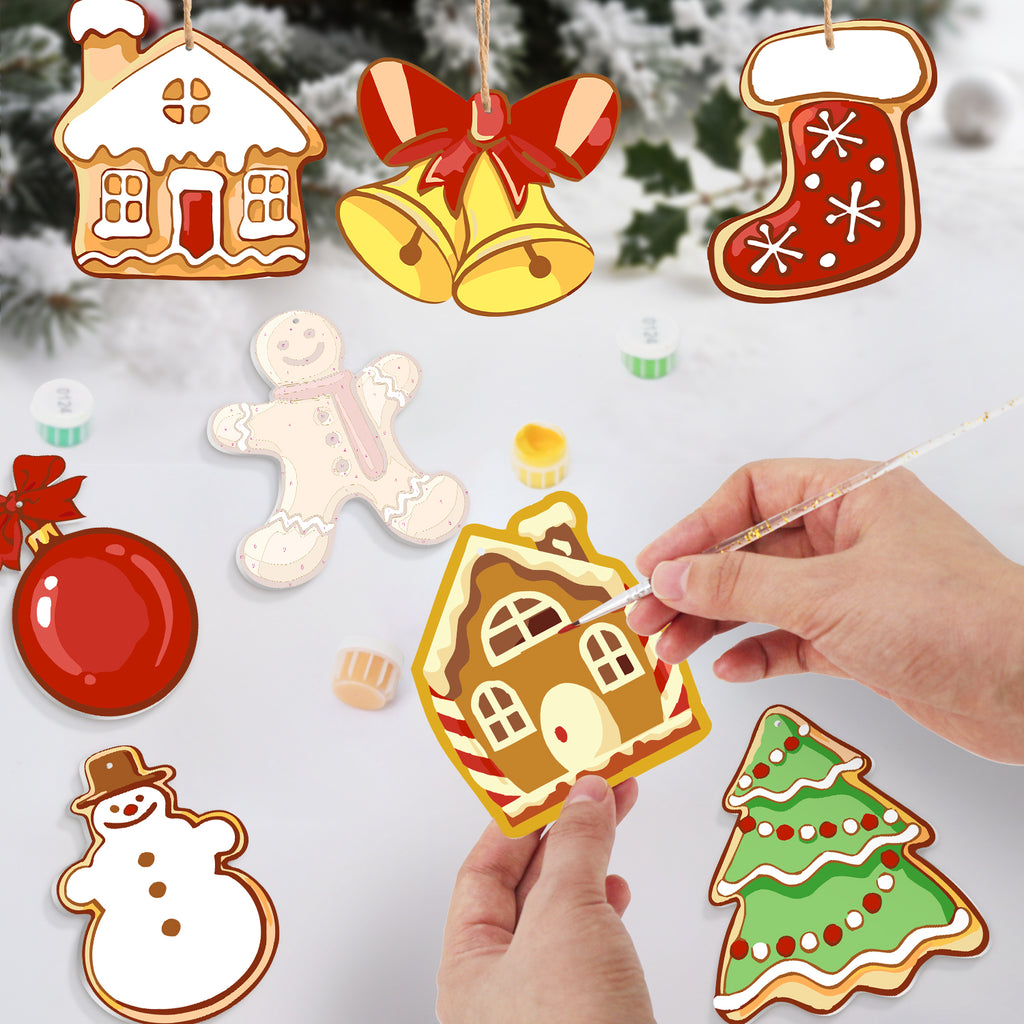 Decorative Christmas ornaments including a gingerbread house, bell, stocking, gingerbread man, snowman, and tree on a snowy background.