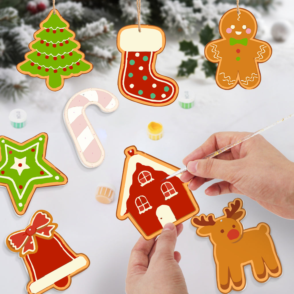 Decorative Christmas ornaments including a house, tree, stocking, and reindeer on a snowy background.