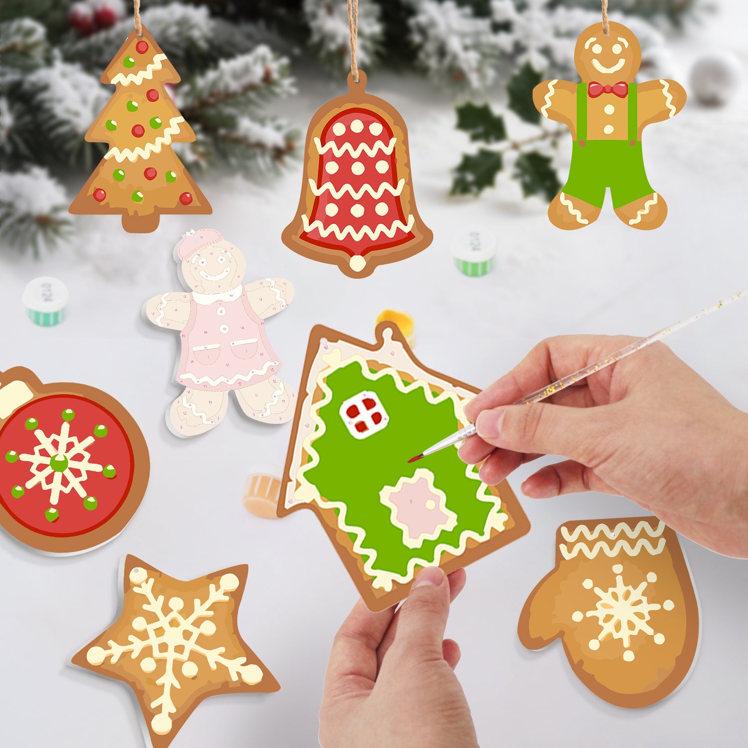 Decorative Christmas cookies being painted with a snowy background