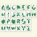 Alphabet letters with leaf designs on a beige background